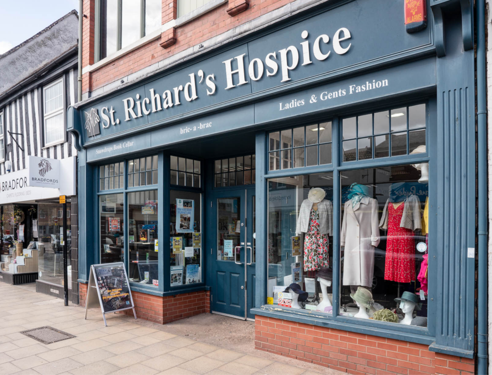 This button takes you through to the find a shop page. The image shows the front of a St Richard's Hospice shop.