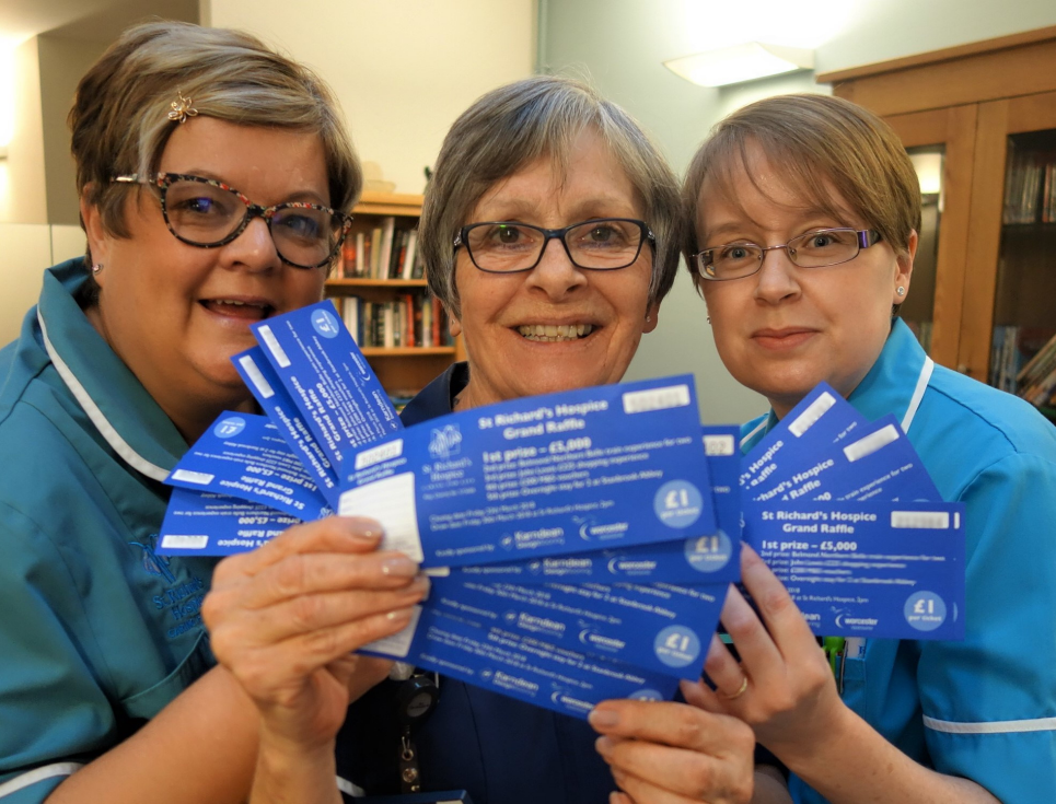 This button takes you to a page on raffles and lotteries. The button image is of three people in nurses' uniforms holding blue raffle tickets.