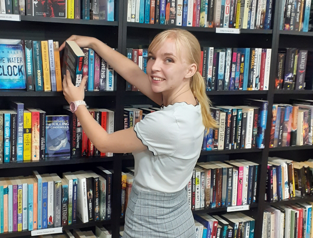 This button takes you to the page on volunteering for St Richard's Hospice. The button image is a person stacking books onto bookshelves.