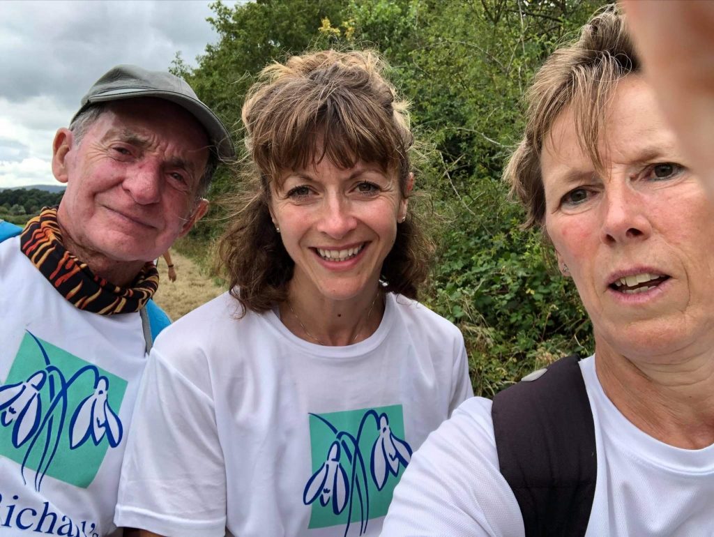 Three people wearing St Richard's Hospice branded t shirts