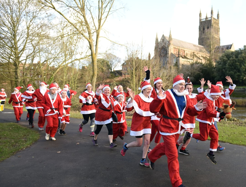 A group of Santas in red suits and white beards set off on the St Richard's Santa Dash fun run.