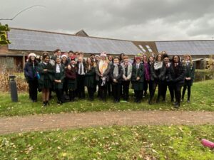 School children gather together in the gardens of St Richard's Hospice to pose for a group picture.