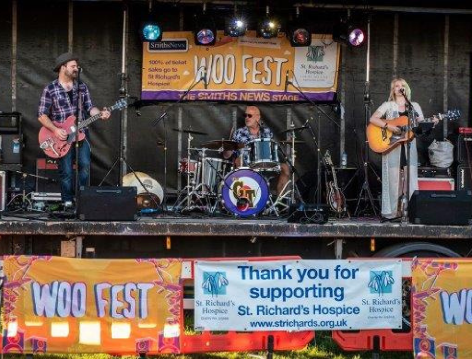 A band play together on the Woo Fest festival stage.