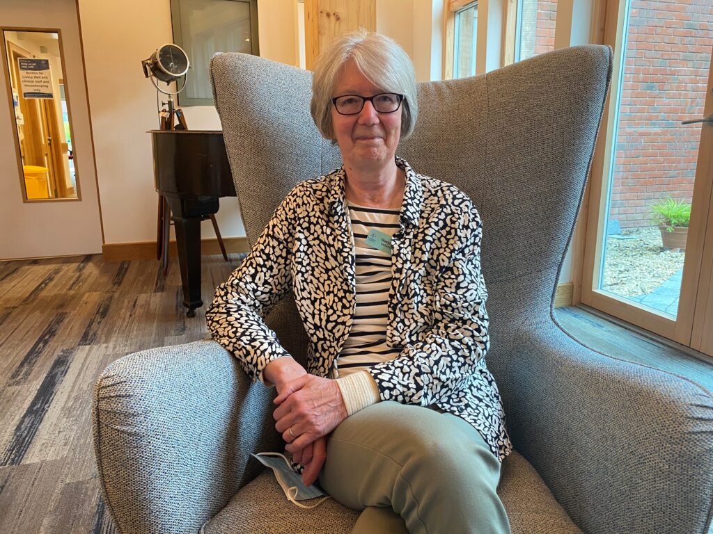 Gwyneth sits in a comfy chair in the hospice reception area. 