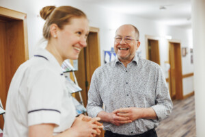 Mike Wilkerson and physiotherapist Charlotte Nicholls chat together in the Living Well Centre.