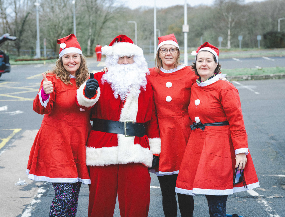 Santa with three female elves.