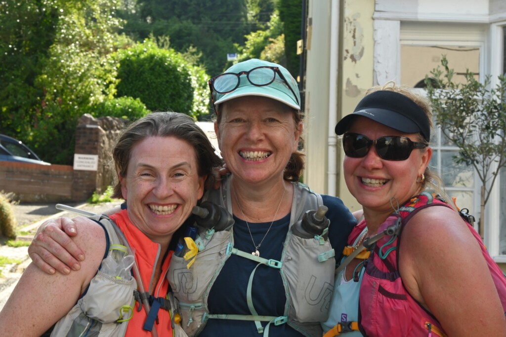 Three smiling women in walking  gear at the end of the walk