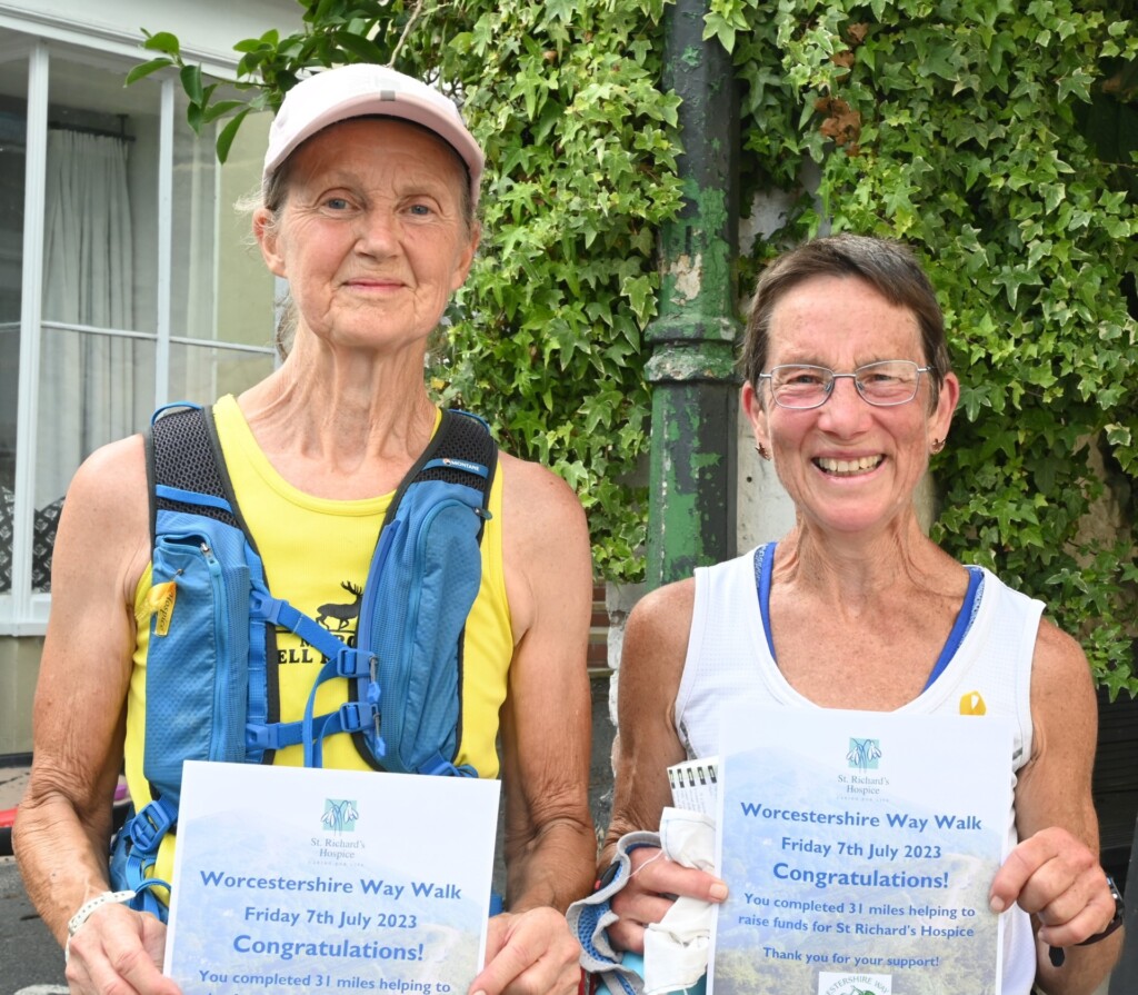Two women in walking gear holding Worcestershire Way Walk certificates after completing the 31 mile walk.