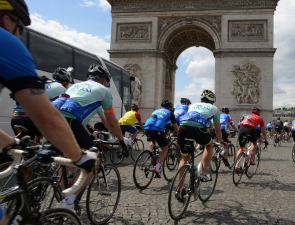 Cyclists in a race, cycling around the Arc de Triomphe,Paris.