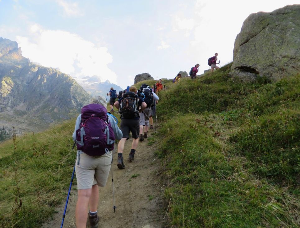 A group of walkers tackling the Alps