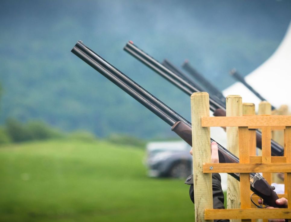 Guns stacked up for a clay pigeon shoot