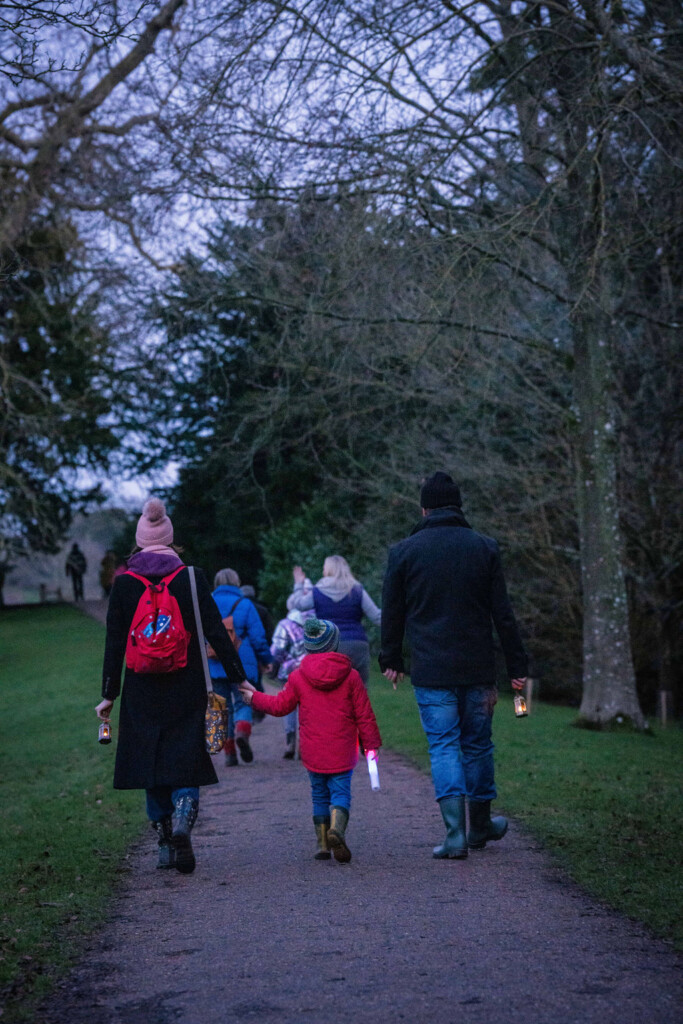 Walkers take part in the hospice's Lantern Walk through the grounds of Croome Court at dusk.