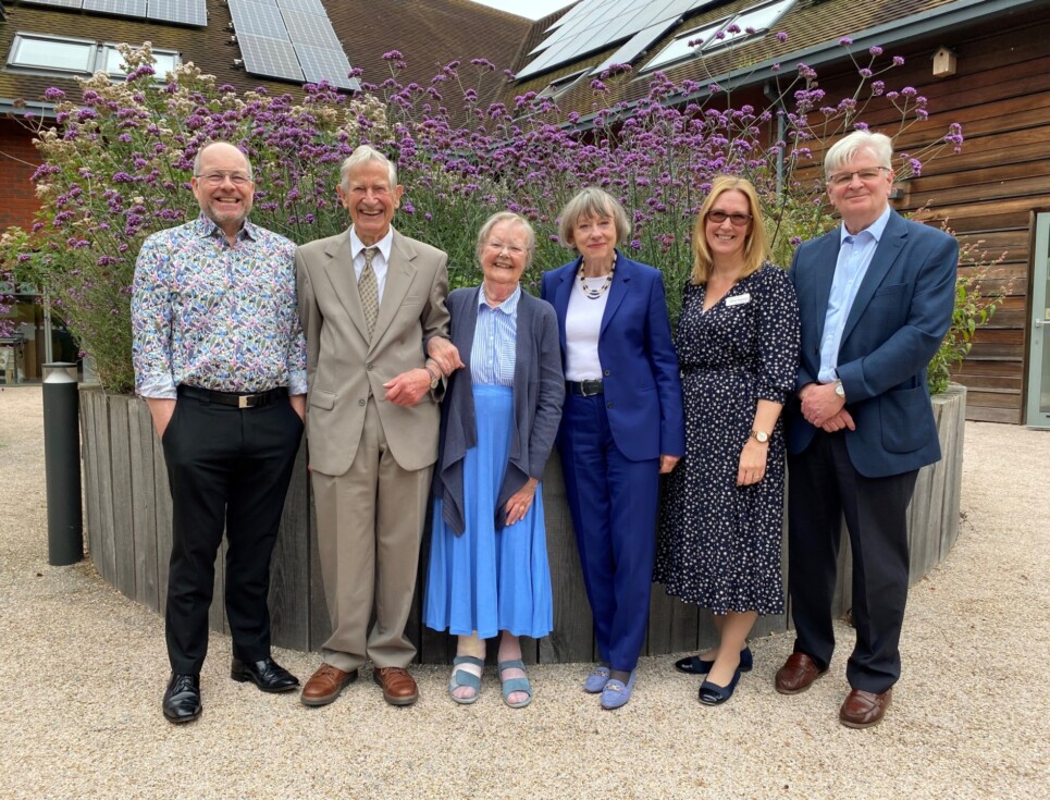 A group of six people standing in the garden of St Richard's Hospice. Left to right: Mike Wilkerson, Chief Executive; Peter Bulman; Dr Jenny Bulman; Jenny Cowpe, Chair of Trustees; Debbie Westwood, Care Director and Galen Bartholomew, Vice Chairman.
