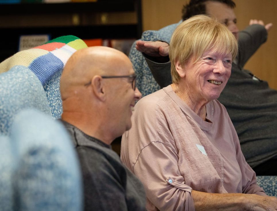 Three people sit on comfy chairs in the hospice's Living Well Centre.