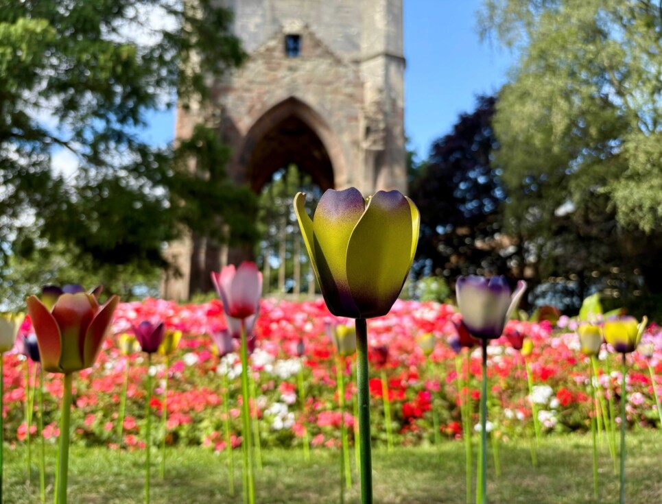 Tulip sculptures are shown amongst colourful summer flowers in The Spire gardens, Worcester